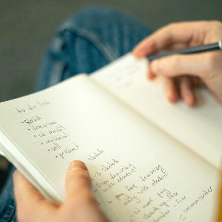 person writing a to do list